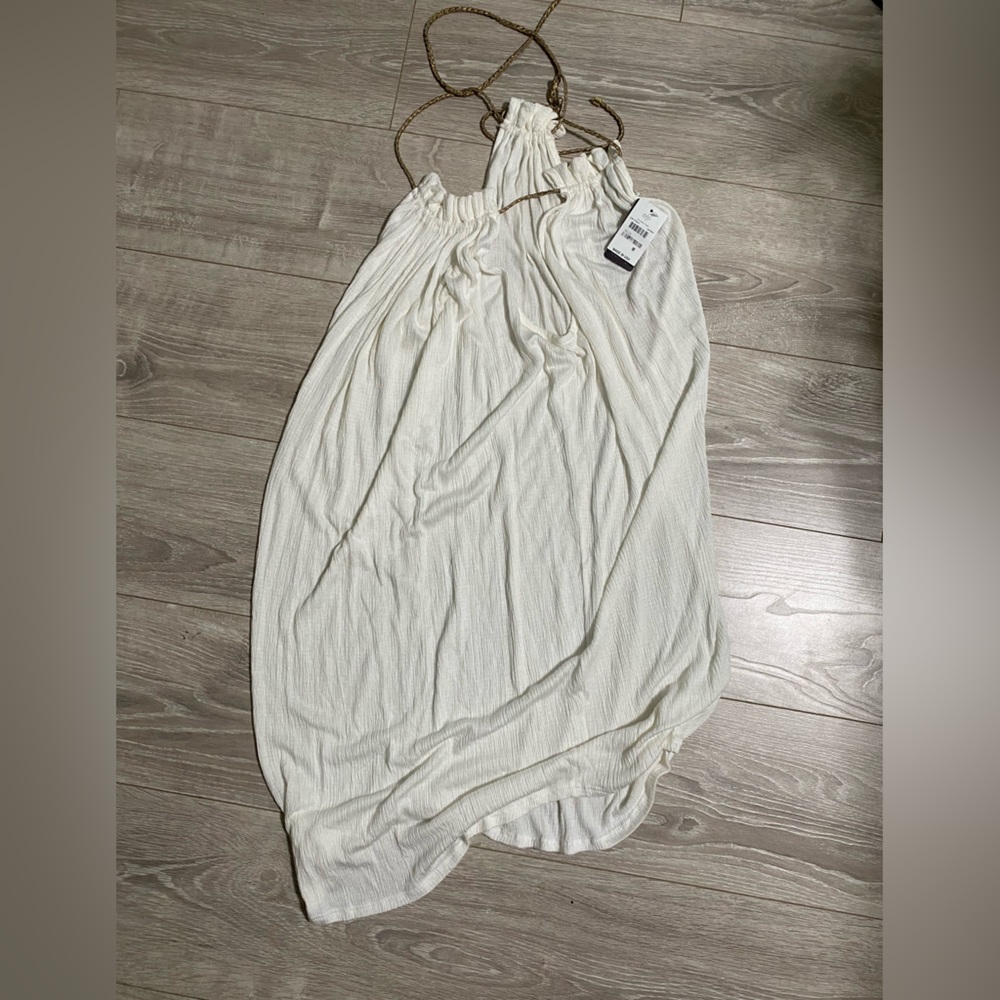 White dress with gold tassels